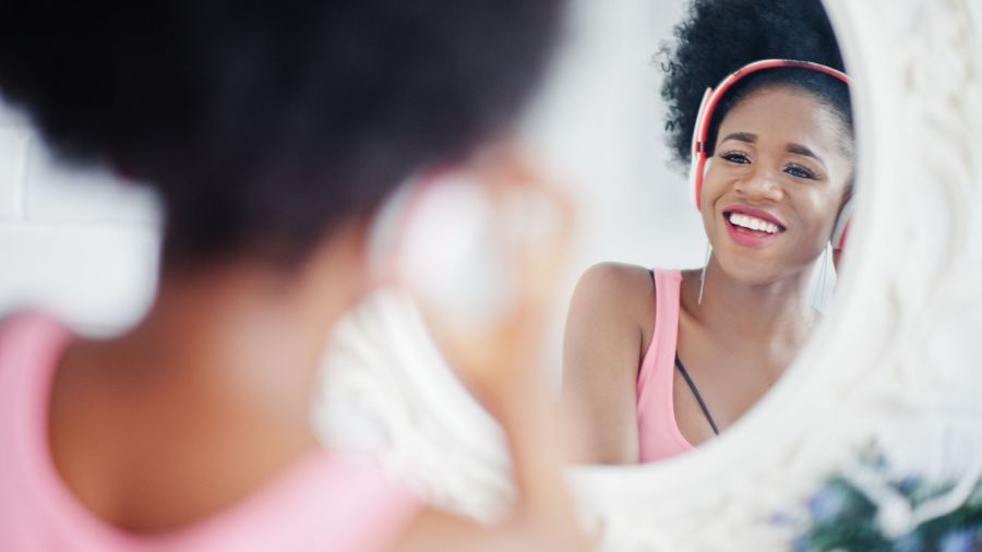 Happy Black Woman Smiling In Mirror